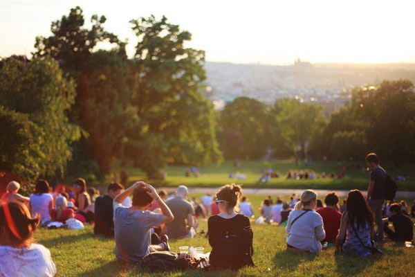 Group of people in a crowd in an urban green space:park