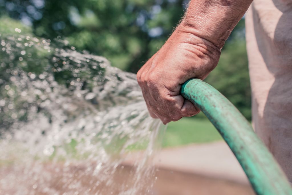 man spraying water