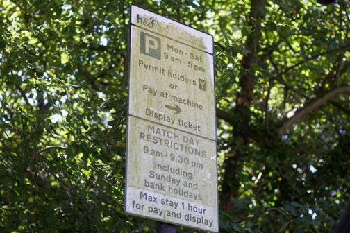 street sign covered in dirt before clean